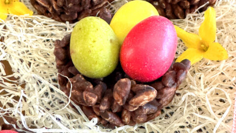 Nids de Pâques façon rose des sables au riz soufflé & chocolat (sans gluten ni lactose) avec des oeufs de dinosaure de la marque PECOU à l'intérieur. posé sur du Raphia